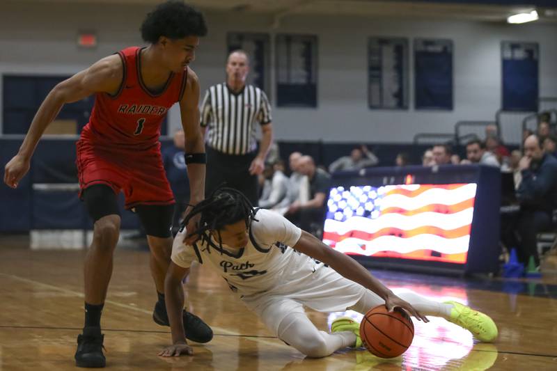 Oswego East's Mason Lockett (23) slips on the court during their basketball game between Bolingbrook at Oswego East Friday, Jan 30, 2026 in Oswego.