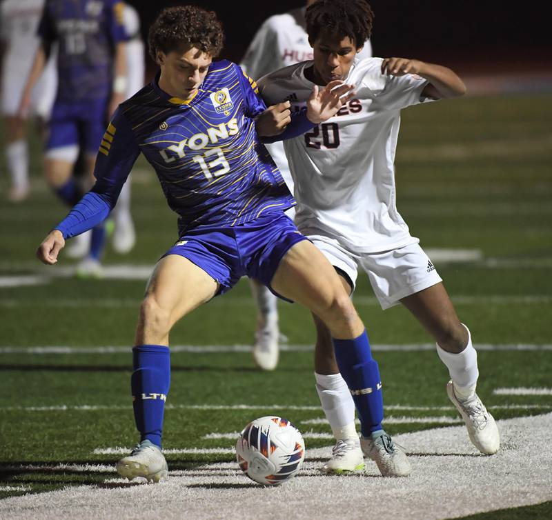 Lyons Township’s Harrison Hoekstra keeps Naperville North’s Andrew Hebron from the ball in the Class 3A state soccer semifinal game in Hoffman Estates on Friday, November 3, 2023.
