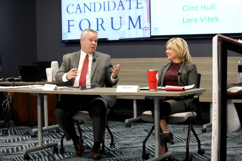 Clint Hull, St. Charles mayoral candidate, answers a question as Mayor Lora Vitek, who is running for re-election, looks on during a candidate forum hosted by the St. Charles Area Chamber of Commerce on Thursday, March 6, 2025 at the Realtor Association of the Fox Valley in St. Charles.