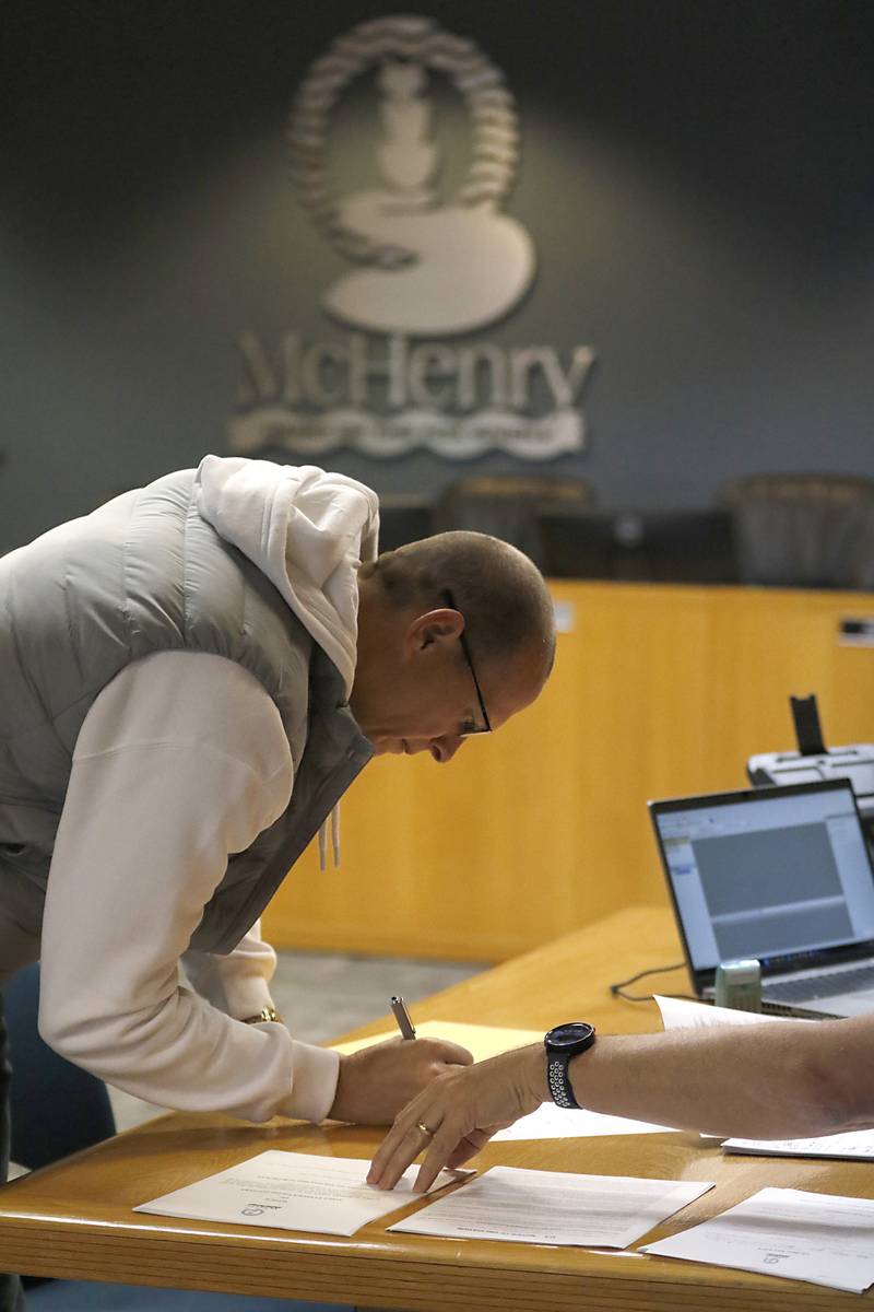 McHenry Mayor Wayne Jett files his paperwork Tuesday, Nov. 12, 2024, to run for another term as mayor of McHenry with McHenry Deputy Clerk Monte Johnson during first day of filing for the consolidated election on April 1, 2025.