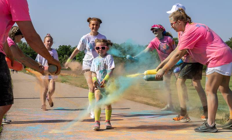 Runners get covered in color at a color station near the end of the course during CASA DeKalb County's annual 5K Color Run on Saturday, June 3, 2023. The color run started at 8:30 a.m. Saturday at the Sycamore Middle School, 150 Maplewood Dr.