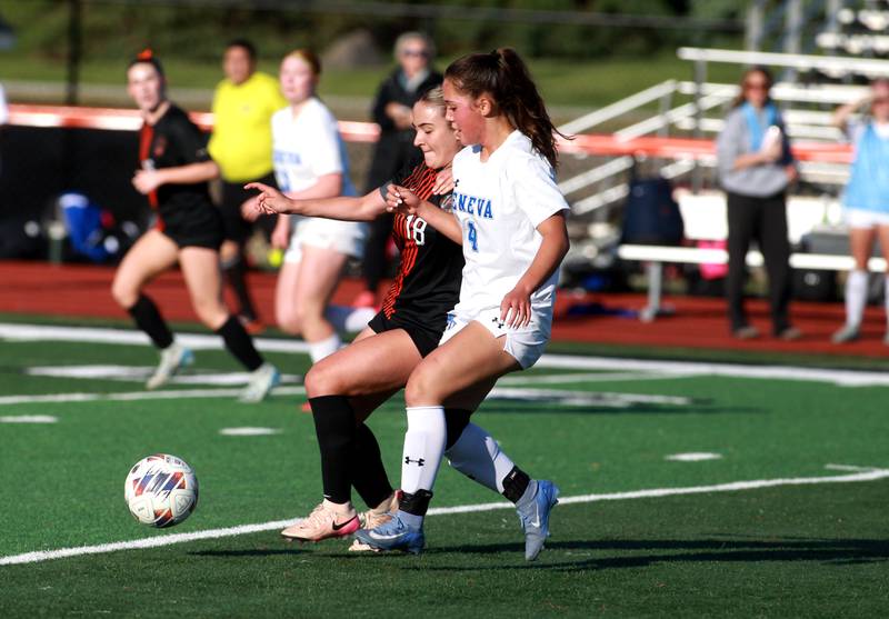 St. Charles East's Payton Rivard (left) and Geneva's Alyssa Houk go after the ball during the Class 3A St. Charles East Regional final on Friday, May 23, 2025 in St. Charles.