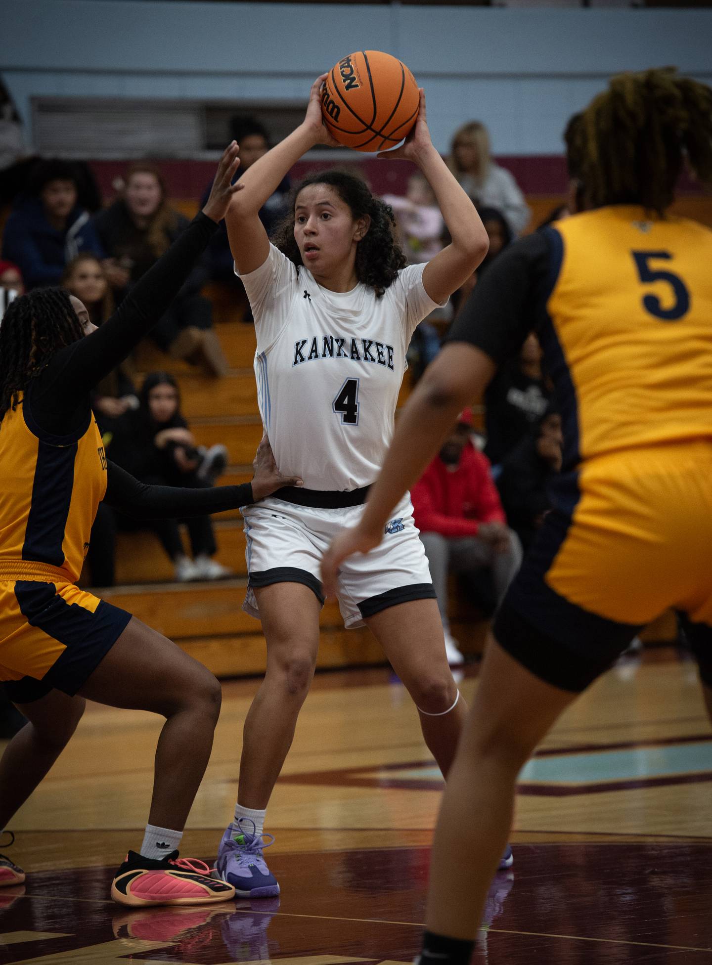 Kankakee's Malea Harrison looks to pass as Thornwood's Nasiyah Baker, left, defends in a game on Thursday, December 11, 2025.