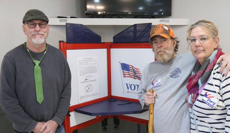 Election judges (from left) Steve Johnson, Mike Gage and Amy Conrad pose for a photo by a voting booth on Tuesday, March 17, 2026 at the Ottawa Lions Club.