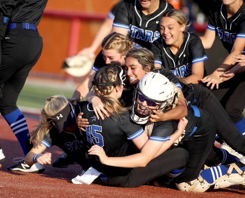 St. Charles North players pile onto the mound following their Class 4A Rosemont Supersectional win over Whitney Young on Tuesday, June 7, 2022.