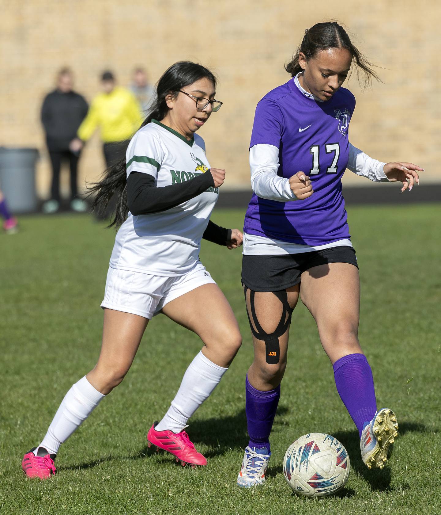 Dixon’s Kamille Prather and North Boone’s Aaliyah Rodriguez look to gain control of the ball Tuesday, April 15, 2025.