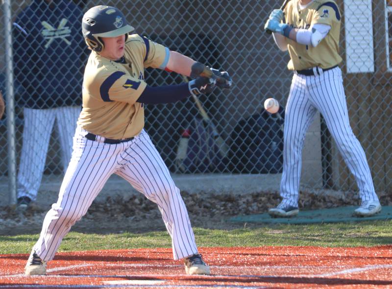 Marquette's Braxton Nelle lays down a bunt against Newark on Monday, March 23, 2026 at Newark High School.