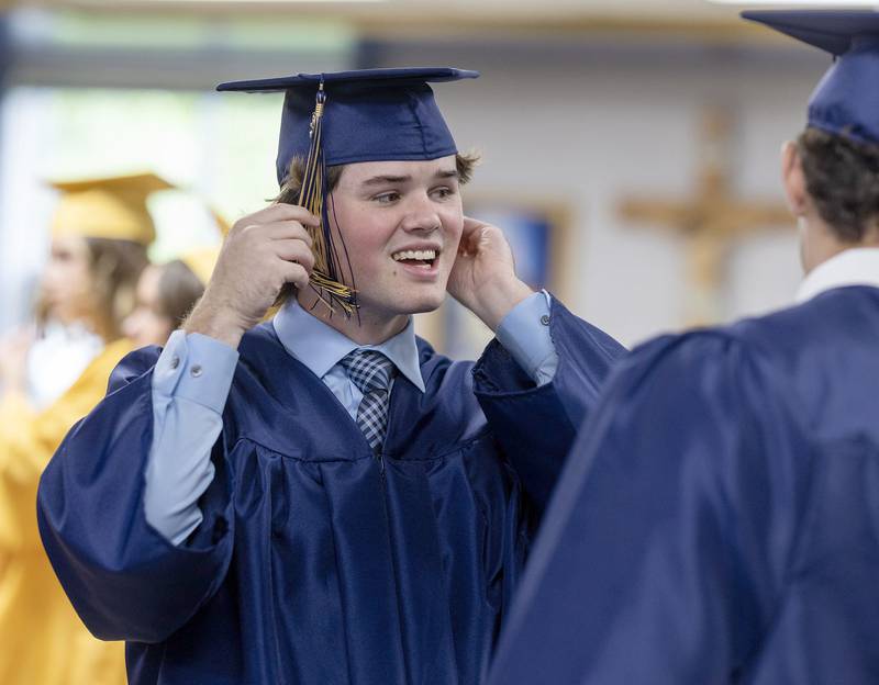 Marquette graduate Ashton Grady adjusts his cap before the commencement ceremony on Sunday, May 25, 2025 in Bader Gymnasium at Marquette High School.
