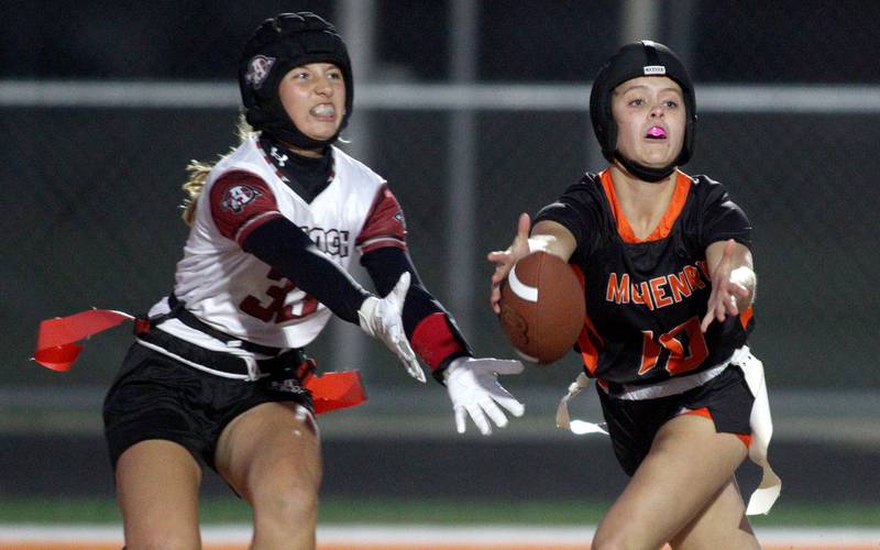 Antioch’s Reese Queensland, left, and McHenry’s Avery Stinger look for the ball  in IHSA Regional Title Game action flag football at McHenry High School in McHenry on Thursday, Oct. 10, 2024.