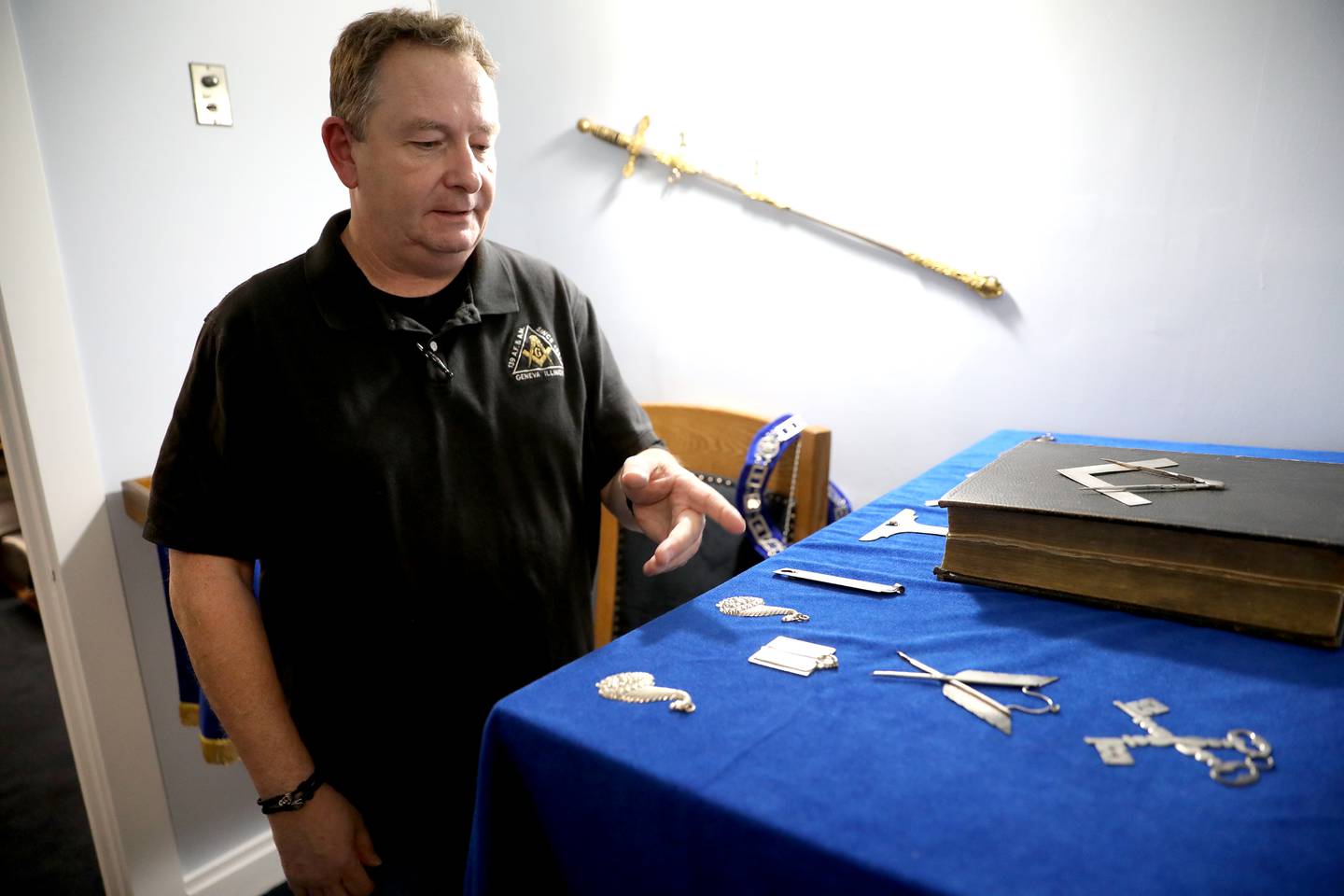 Jacob McConnell, senior warden with Geneva Masonic Lodge 139, shows the organization’s original Bible and jewelry pieces during an open house on Friday, Oct. 25, 2024 in honor of the 170th anniversary of the lodge.