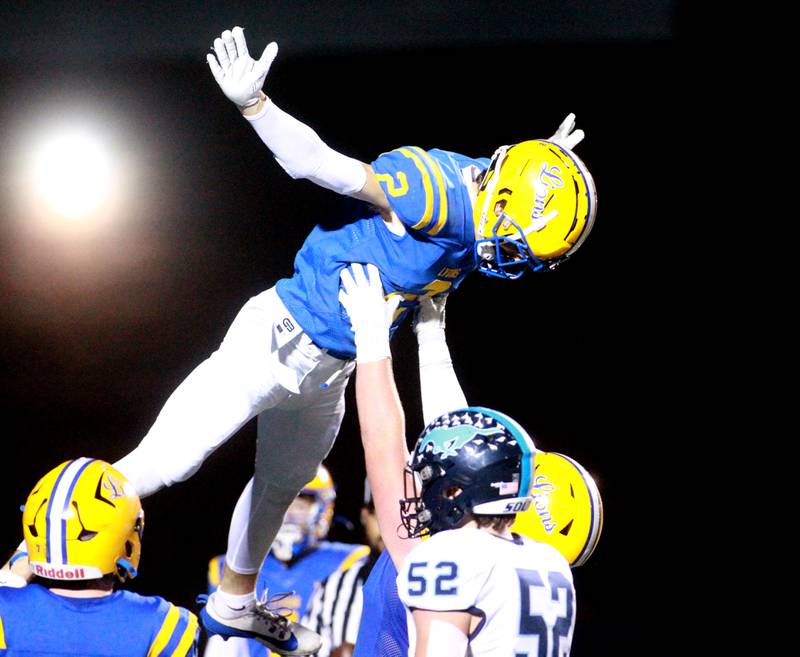 Lyons Township’s Travis Stamm is lifted up in celebration of a touchdown during the Class 8A second-round game against Downers Grove South on Friday, Nov. 8, 2024 at Lyons Township in Western Springs.