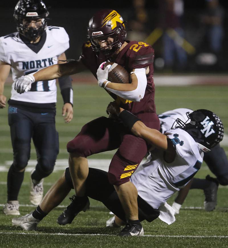 Richmond-Burton's Hunter Carley tries to break the tackle attempt of Woodstock North's Parker Halihan during a Kishwaukee River Conference football game on Friday, Oct. 11, 2024, at Richmond-Burton High School.