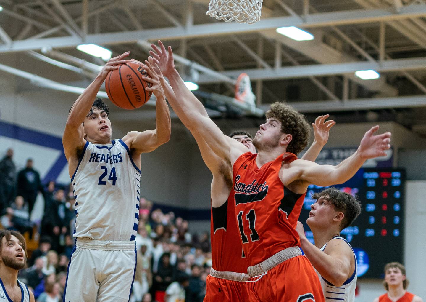 Plano's Samuel Sifuentes (24) rebounds the ball against Sandwich’s Dylan Young (11) during a basketball game at Plano High School on Friday, Jan 20, 2023.