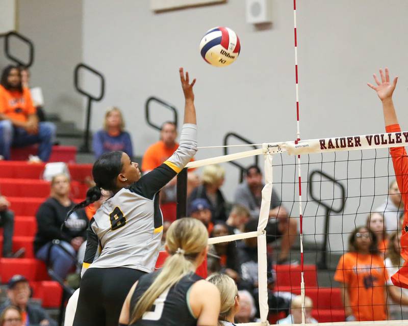 Joliet West's Eden Eyassu (8) tips the ball over the net during Class 4A Bolingbrook Sectional semifinal match between Joliet West at Oswego.  Nov 5, 2024  in Bolingbrook.