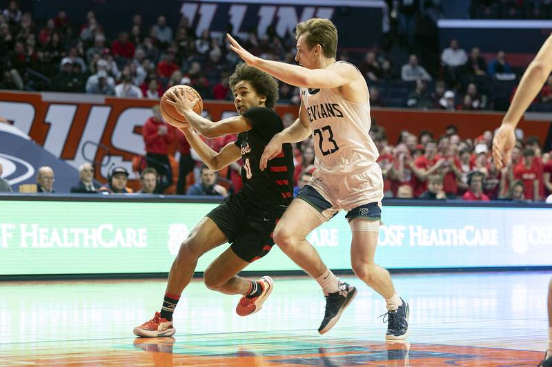 Benet Academy’s Brayden Fagbemi drives to the hoop against New Trier’s Jake Fiegen Friday March 10, 2023 during the 4A IHSA Boys Basketball semifinals.