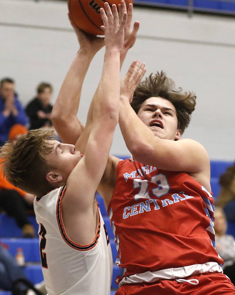 Marian Central's Cale McThenia drives to the basket assigns DeKalb's Sean Reynolds  during a Central High School’s Dr. Martin Luther King, Jr., Boys Basketball Tournament game Friday, Jan. 13, 2023, at Central High School in Burlington.