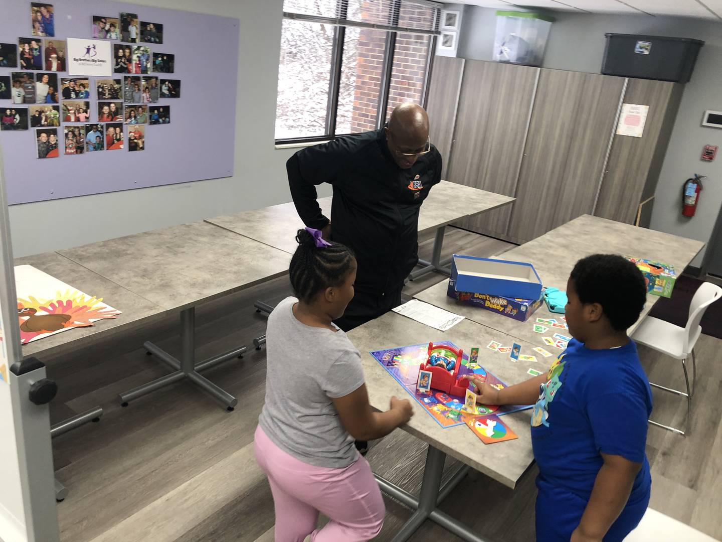 Terry Byrd, a volunteer with Big Brothers Big Sisters of McHenry County, plays board games with "Littles" Kennedi and Kaiden, on Friday, Jan. 19. The local organization needs more adult volunteers to serve its 50-child waiting list.