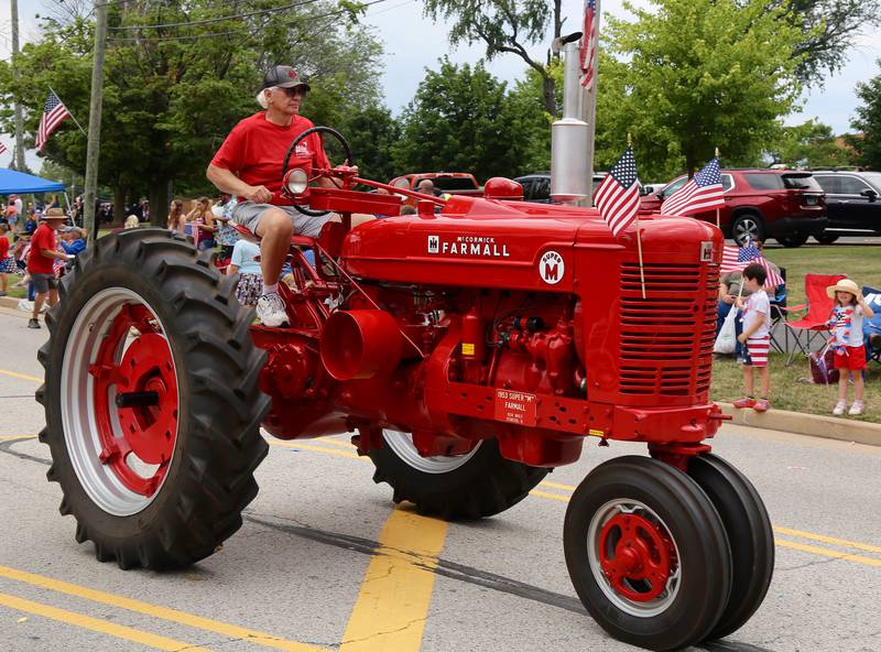 Ken Wolf of Oswego drives a tractor in the Yorkville Independence Day Parade on Friday, July 4, 2025.