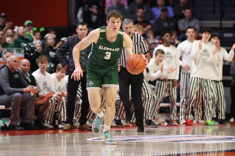 Glenbard West’s Caden Pierce works the ball up court against Whitney Young in the Class 4A championship game at State Farm Center in Champaign. Saturday, Mar. 12, 2022, in Champaign.