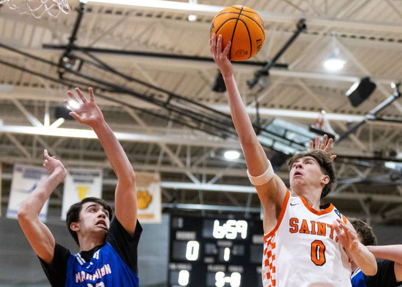 St. Charles East Guard Sam Tisch goes up for a layup during a game against Marmion Academy on Saturday, Jan. 4, 2025.