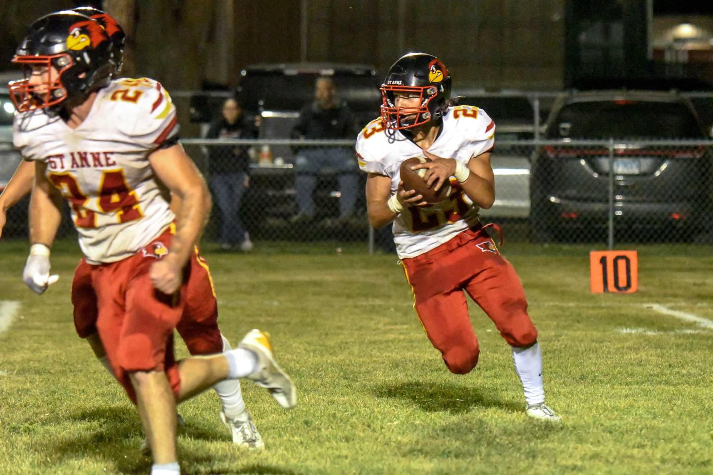 St. Anne's Gavin Threm looks to run the ball against Milford-Cissna Park defenders during St. Anne's 61-28 victory over Milford-Cissna Park on Thursday, Oct. 16, 2025.