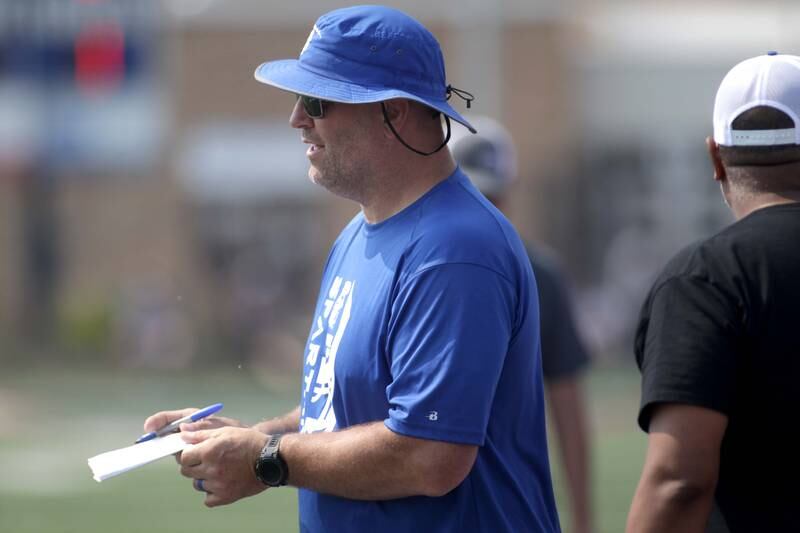 St. Francis Head Coach Bob McMillen watches his team during a 7-on-7 football tournament at West Aurora High School on Friday, June 23, 2023.