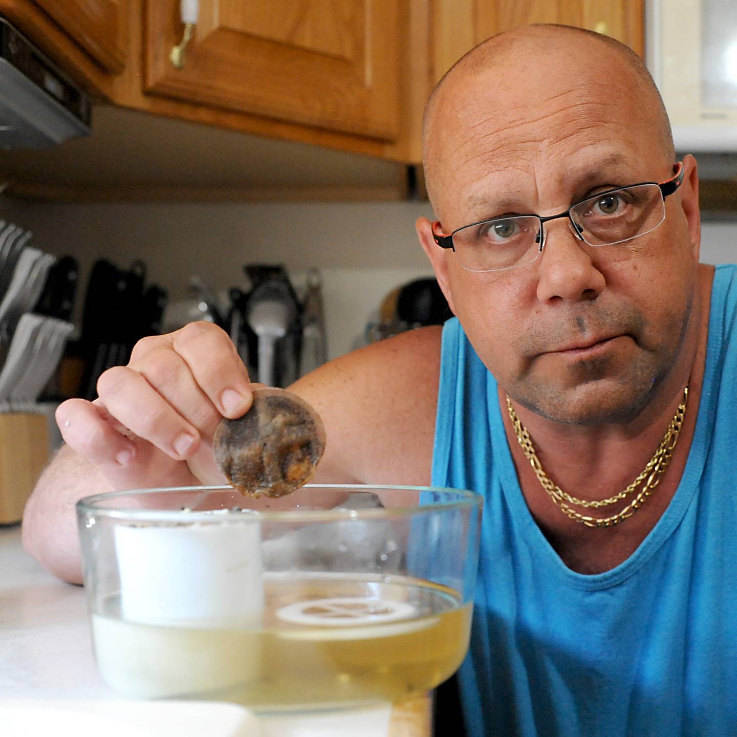 Scott Martens holds a water filter that is used to try and improve the the water quality of the water that comes from water utility that serves Johnsburg on Wednesday, June 29, 2022. Residents in Johnsburg are on a private water system and say the clarity and smell of the water can be awful at times.