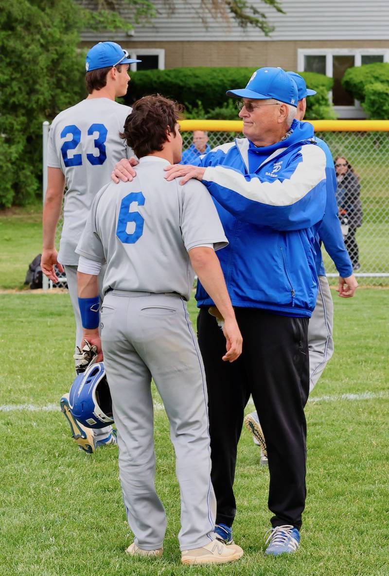 Princeton coach Wick Warren, who is retiring after 10 years at the Tigers helm, talks to PHS senior Ace Christiansen after Monday's 5-2 regular-season ending loss to Kewanee.