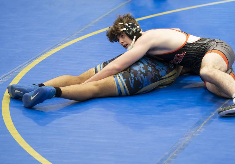 Crystal Lake Central's Tyler Porter tries to get control of Wheeling's Jonathan Martinez in the 175 pound bout during the Class 2A Dual Team wrestling Sectional on Tuesday, February 25, 2025 at Wheeling High School. Ryan Rayburn for Shaw Local
