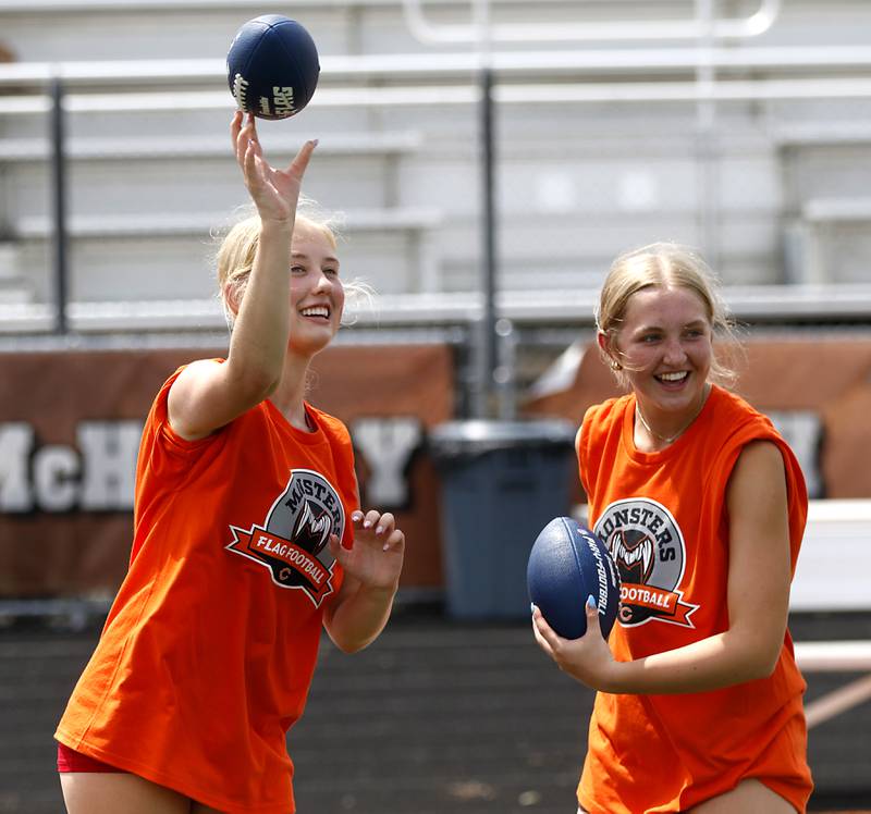 McHenry’s flag football players Holly Waters and Chloe Casey toss a football to campers during the Chicago Bears Mini Monsters Flag Football Camp on Wednesday, July 16, 2025. at McCracken Field in McHenry.