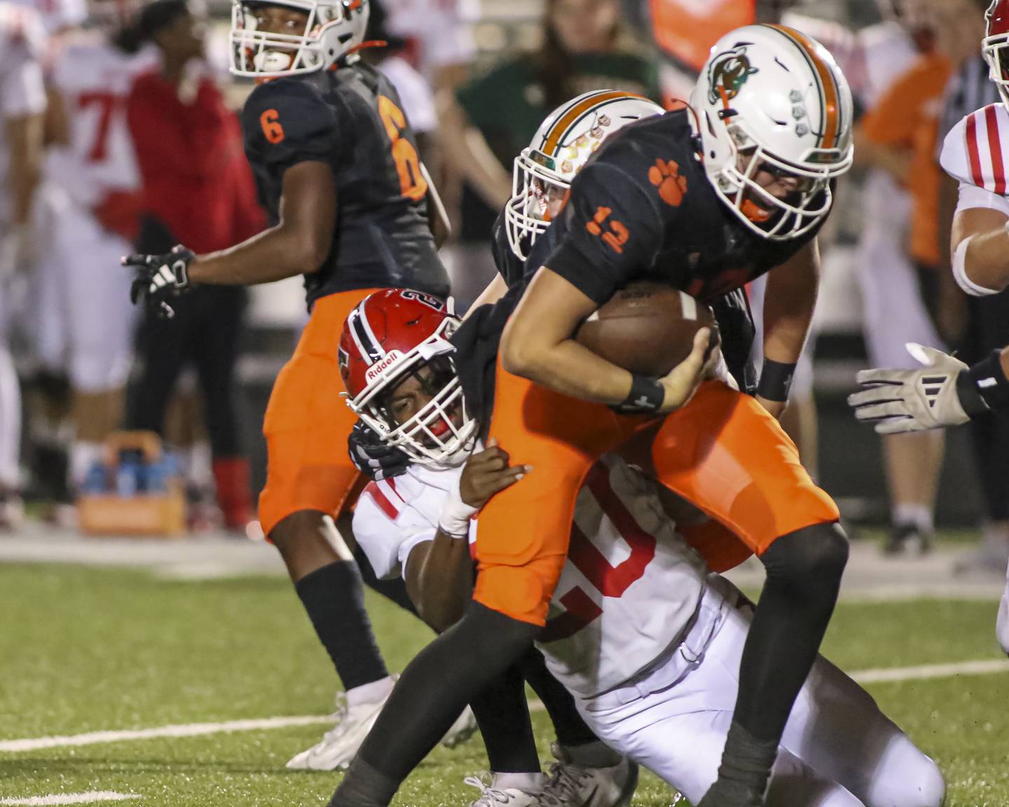 Yorkville's Tyvon Wilson (20) sacks Plainfield East's Brady Cloherty (12) during football game between Yorkville at Plainfield East Friday, Sept 19, 2025 in Plainfield.