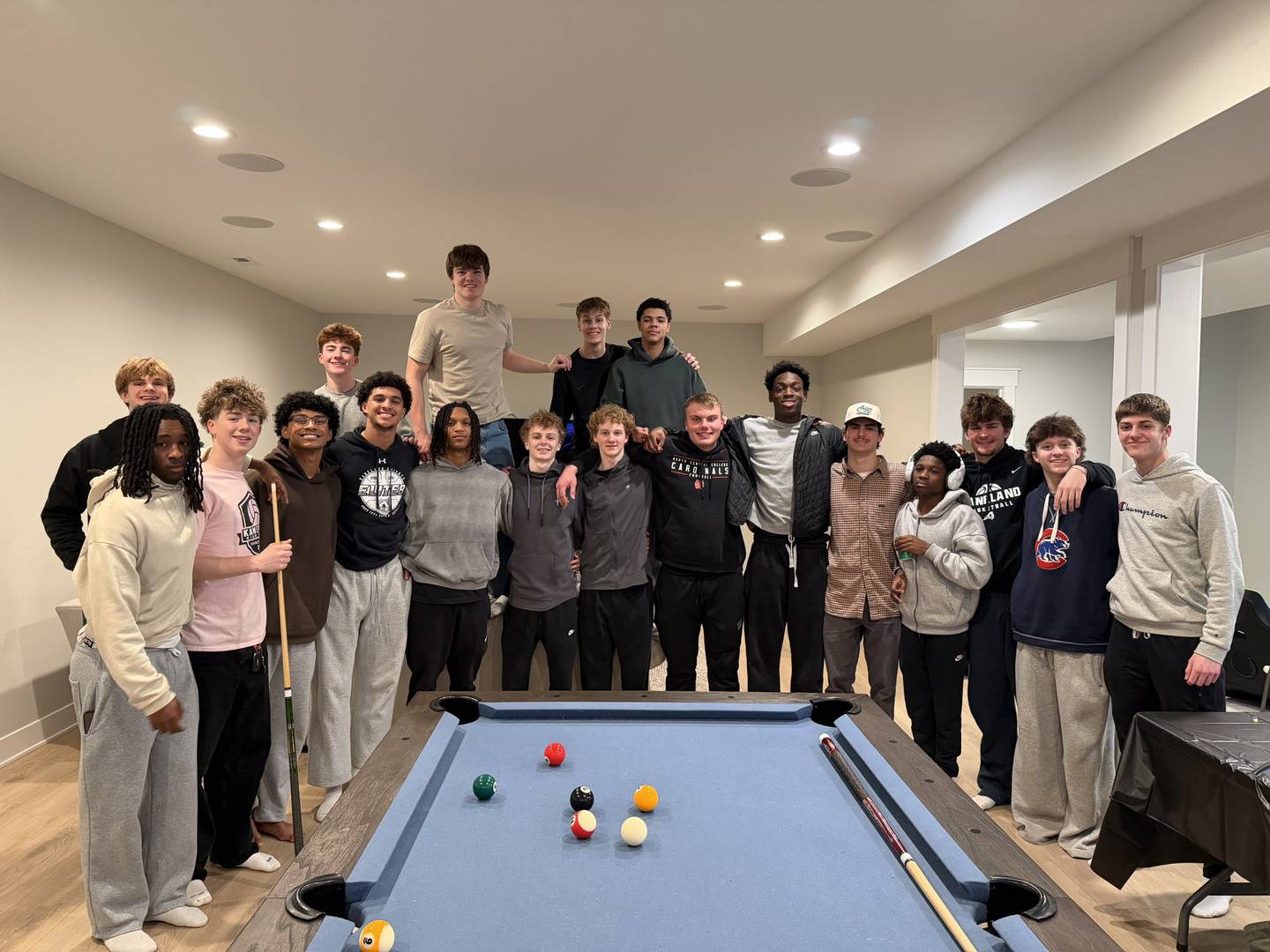 The Kaneland boys basketball team poses for a team photo on the Kimme property before the postseason began last month.