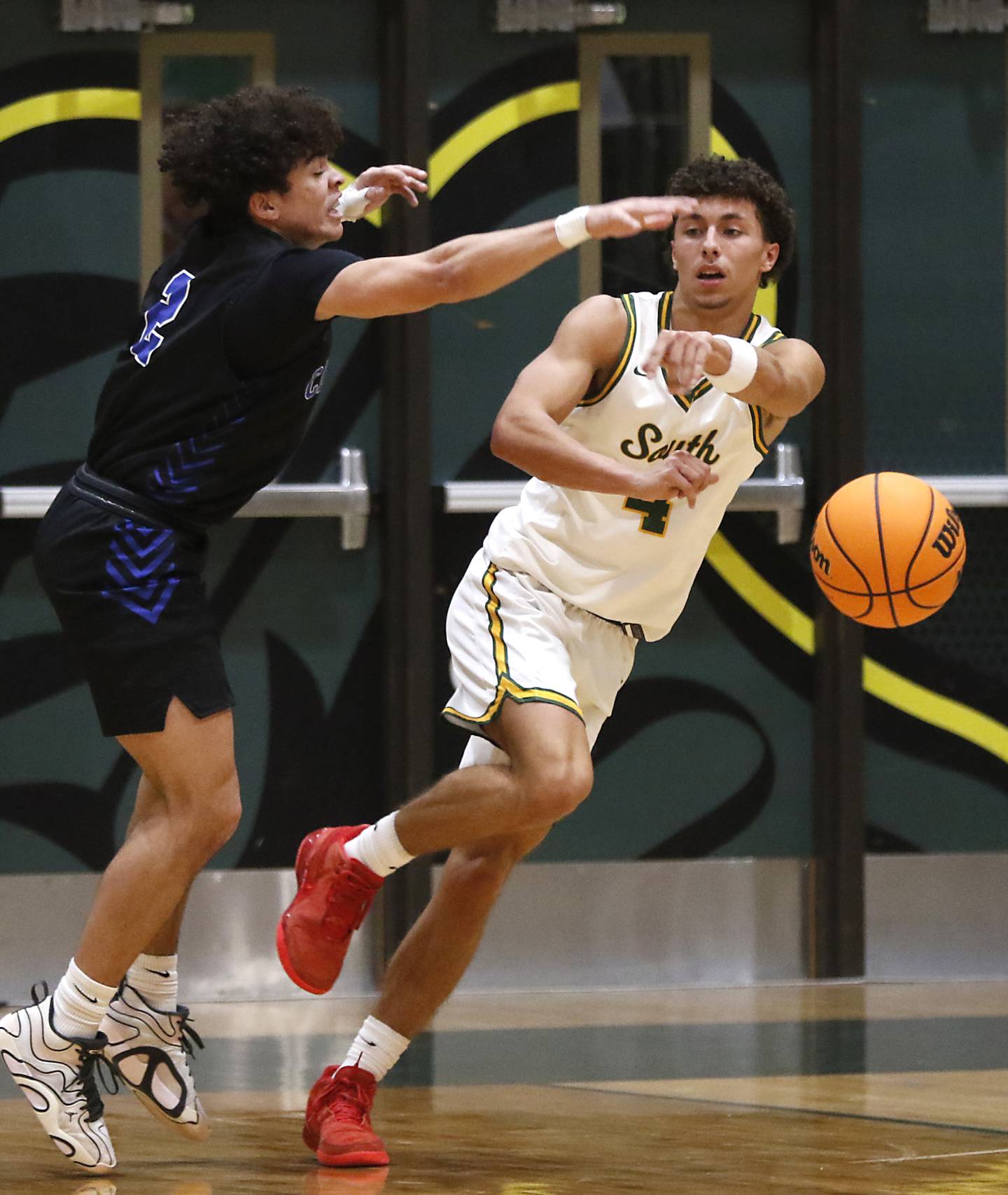 Crystal Lake South's Anthony Demirov pass the ball as he is guarded by Burlington Central's Caden West during a Fox Valley Conference basketball game on Tuesday, Jan. 28, 2025, at Crystal Lake South High School.