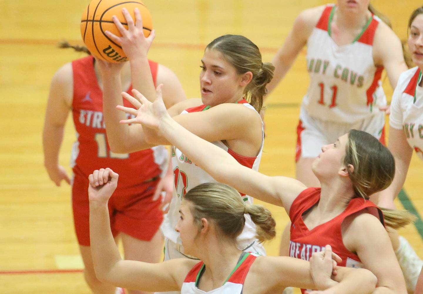 L-P's Phoebe Shetterly grabs a rebound over Streator's Reah Huey as teammate Kelsey Frederick boxes her out on Tuesday, Jan. 28, 2025 in Sellett Gymnasium at L-P High School.