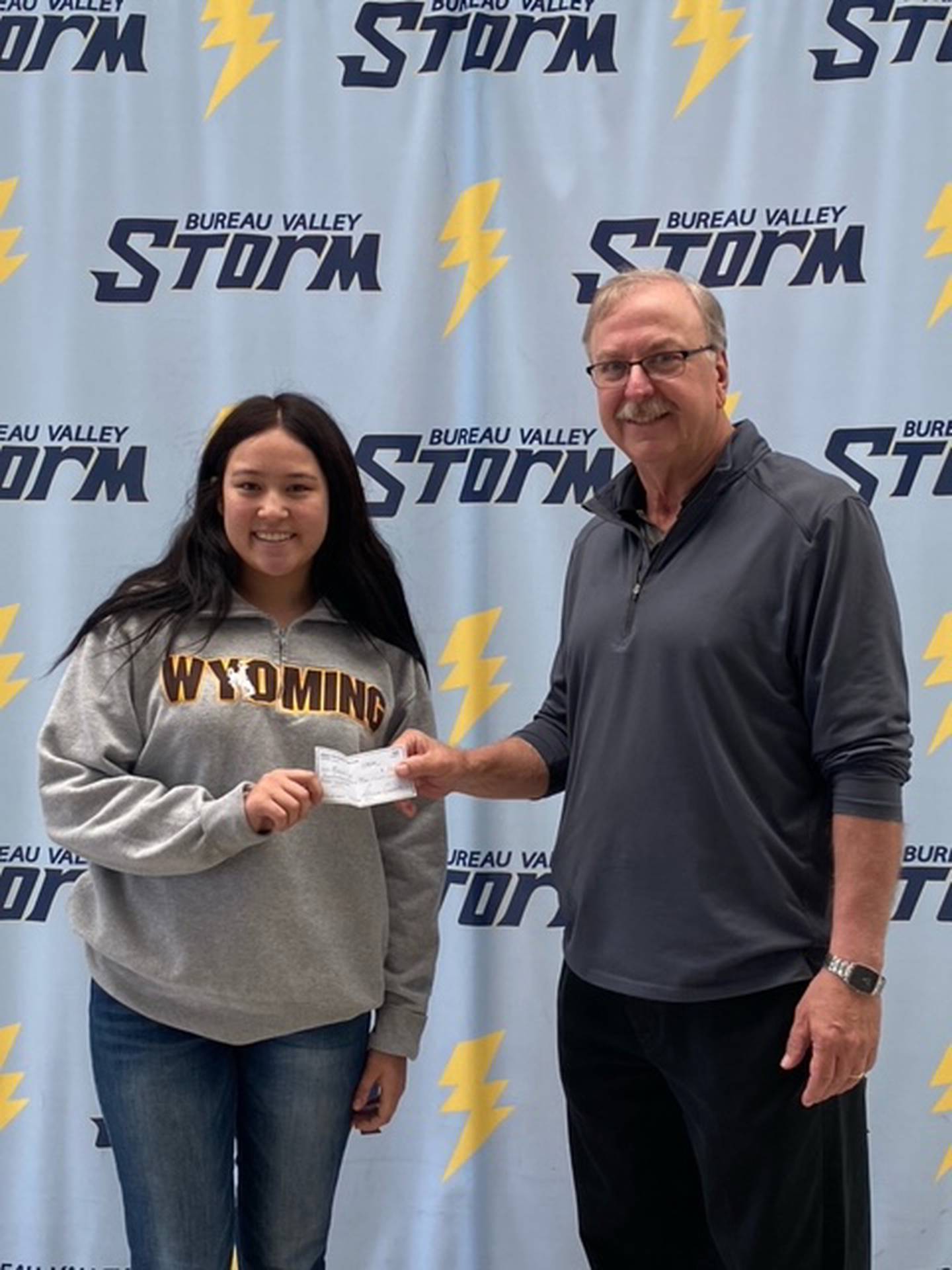 Jim DeVenney (right), Sheffield Lions Club vice president, presents the 2024 Sheffield Lions Club Scholarship check to Bureau Valley High School senior Makalia Craft