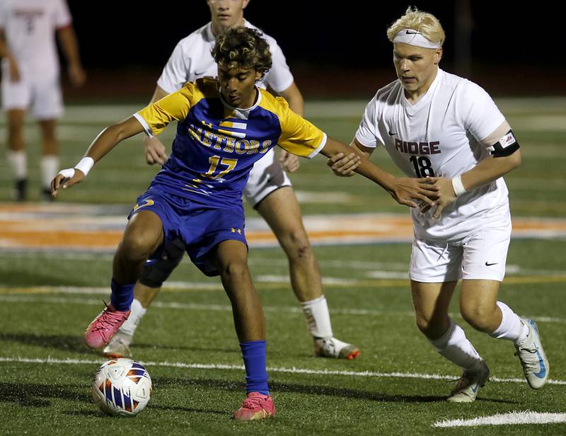 Prairie Ridge's Gabriel Porter grabs Chicago De La Salle's Christian Flores as he tries to control the nball during an IHSA Class 2A state semifinal soccer match on Friday, Nov. 8, 2024, at Hoffman Estates High School.