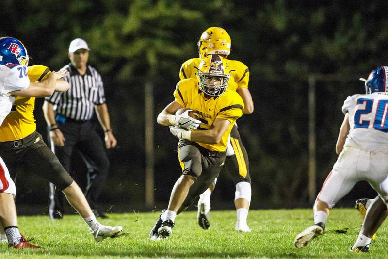Jacobs' Loren Strickland runs up the middle Friday against Dundee-Crown in Algonquin. Jacpbs won, 14-0.