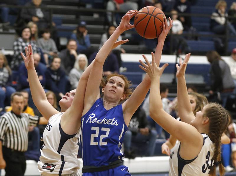 Burlington Central's Paige Greenhagel tries to grab a rebound in between Cary-Grove's Emily Larry and Annika Nordin during a Fox Valley Conference girls basketball game Friday Jan. 6, 2023, at Cary-Grove High School in Cary.