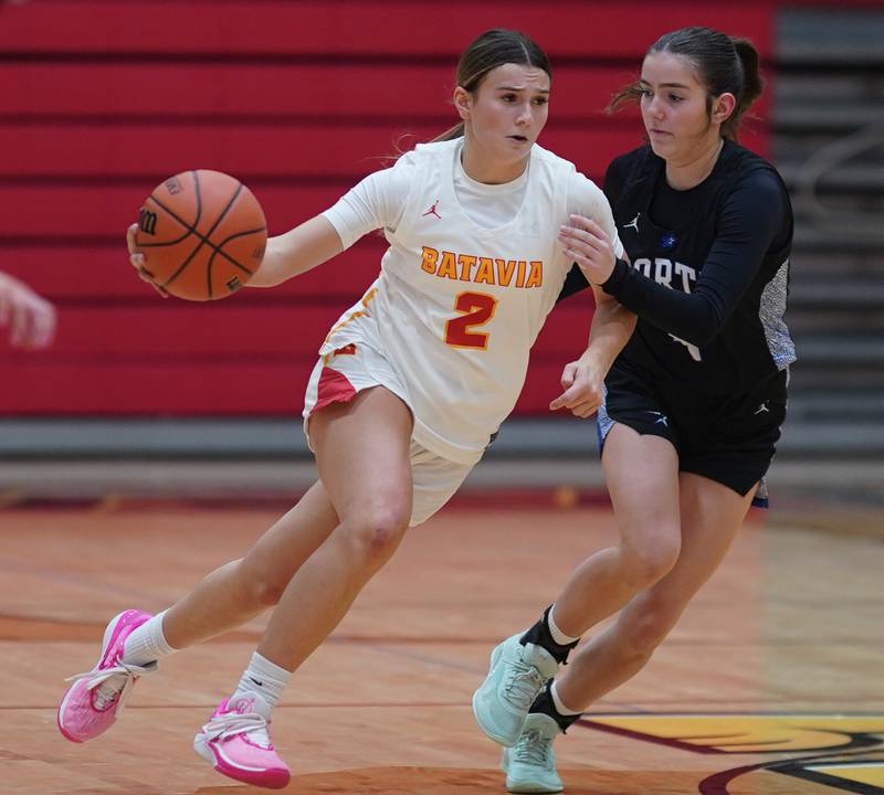 Batavia's Brooke Carlson (2) brings the ball up the court against St. Charles North's Hannah Ganser (4) during a basketball game at Batavia High School on Tuesday, Dec 5, 2023.