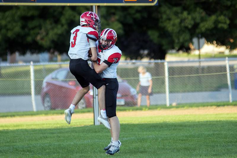 Amboy’s Tucker Lindenmeyer (left) and Troy Anderson celebrate the first score of the game Friday, Aug. 26, 2022 against Polo.