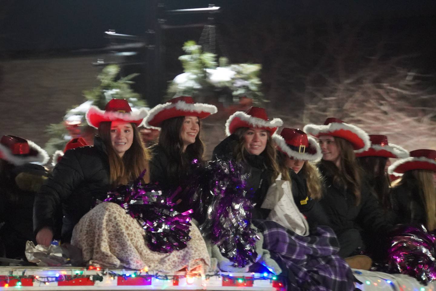 Rochelle Township High School cheerleaders ride in Rochelle's lighted Christmas parade on Friday, Dec. 5, 2025.