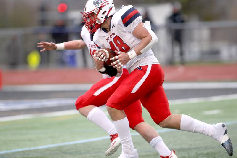 St. Rita's Matt Kingsbury (48) intercepts the ball in for a touchdown during their 7A quarterfinal game against St. Charles North in St. Charles on Saturday, Nov. 12, 2022.