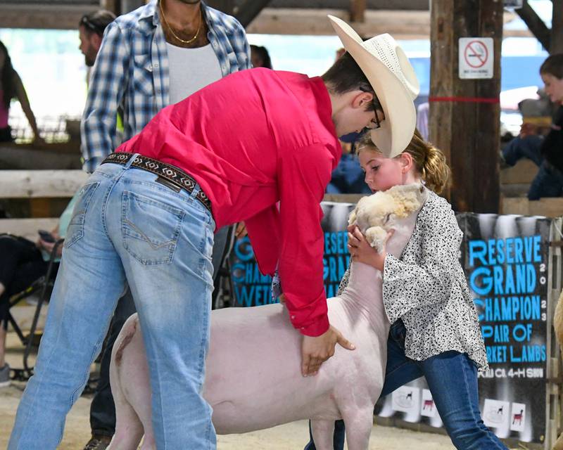 Tony Dupuis (left) judges 10-year-old Maple Park resident Faith Poynter's sheep during the DeKalb County 4-H sheep competition on Friday, Aug. 4, 2023 held at the Sandwich Fairgrounds.