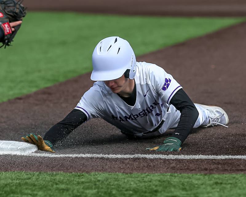 Hampshire's Danny Doherty (14) dives back to first during  pitchoff attempt during baseball game between Dixon at Hampshire.  March 28, 2024