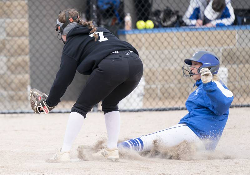 Burlington Central's Savannah L'Huillier slides in safe to home base to score a run as Prairie Ridge's Elena Smith attempts a tag during their game on Wednesday, April 27, 2022 at Burlington Central High School. Ryan Rayburn for Shaw Local