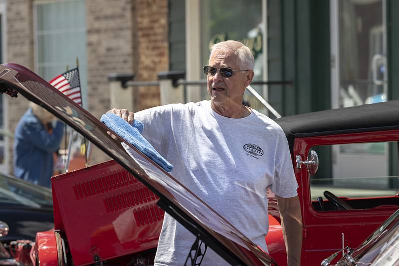 Mark Heckman of Dixon polishes up the hood of his 1966 Chevy Nova Saturday, May 11, 2024 at the 12th annual Lincoln Highway Car Show in Franklin Grove.