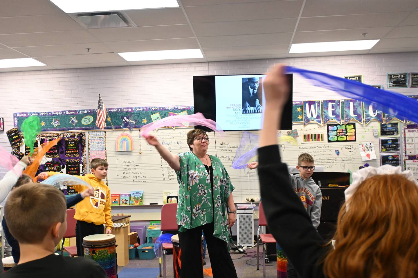 Recently, her class learned an African folk dance from Ghana. Her third-grade class stood in a circle in front of their drums, danced, and sang a song with hand gestures meaning “I keep you in my heart” and “I come in peace.”