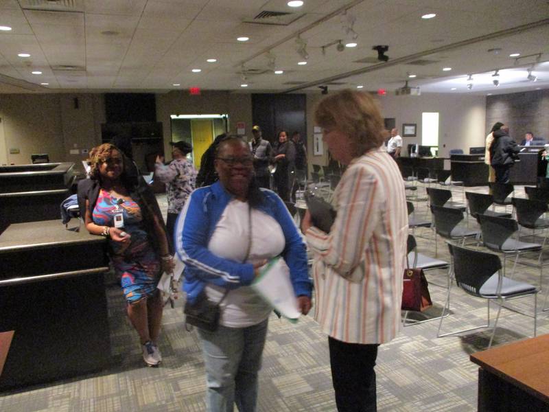 ewell Robinson (center) talks with Councilwoman Sherri Reardon on Tuesday after making an appeal to the Joliet City Council for help in finding her mission son, Robert Long, who disappeared on Thursday. April 17, 2024