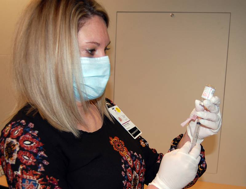 Morris Hospital Pharmacy Director Alyssa Knoderer fills a syringe with the Moderna COVID-19 vaccine on Tuesday, Dec. 29 as vaccine administration continues for hospital staff.