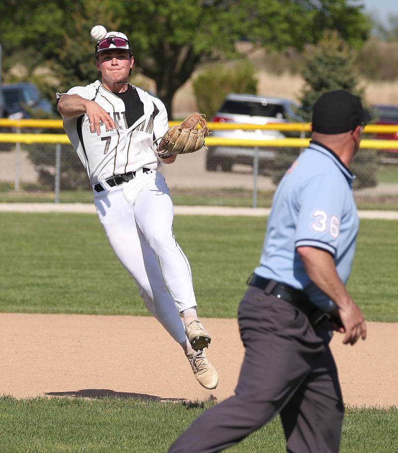 Sycamore's Nathan Lojko throws the ball around the umpire to record an out at first during their game against Ottawa Tuesday, May 6, 2025, at the Sycamore Community Sports Complex.